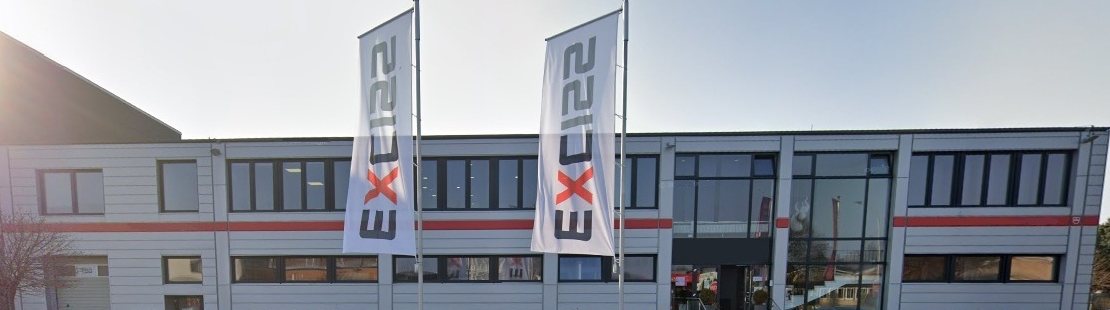 EXCISS GmbH company building in Norderstedt with two flags